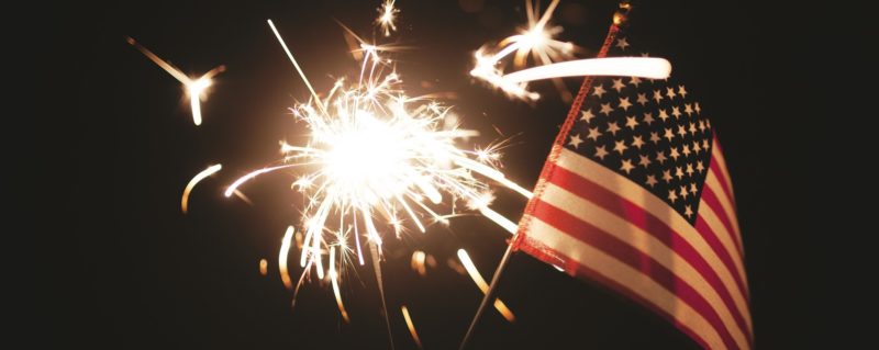 A sparkler in front of an American flag