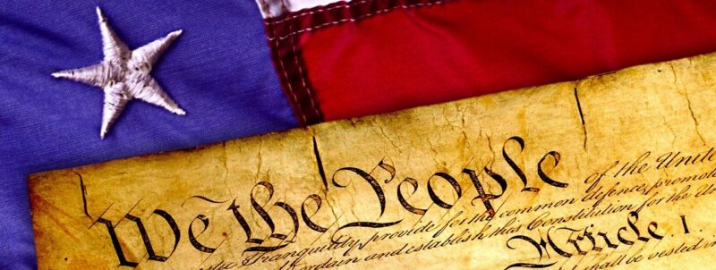 The Declaration of Independence on top of the American flag