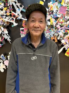 Mr. Duc Vo is wearing a hat and gray sweater.