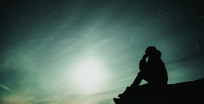 Silhouette of person at night with stars