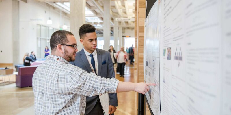 Students looking at a poster board