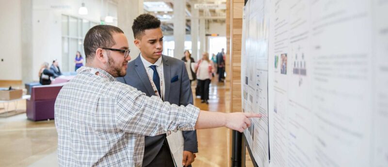 Students looking at a poster board